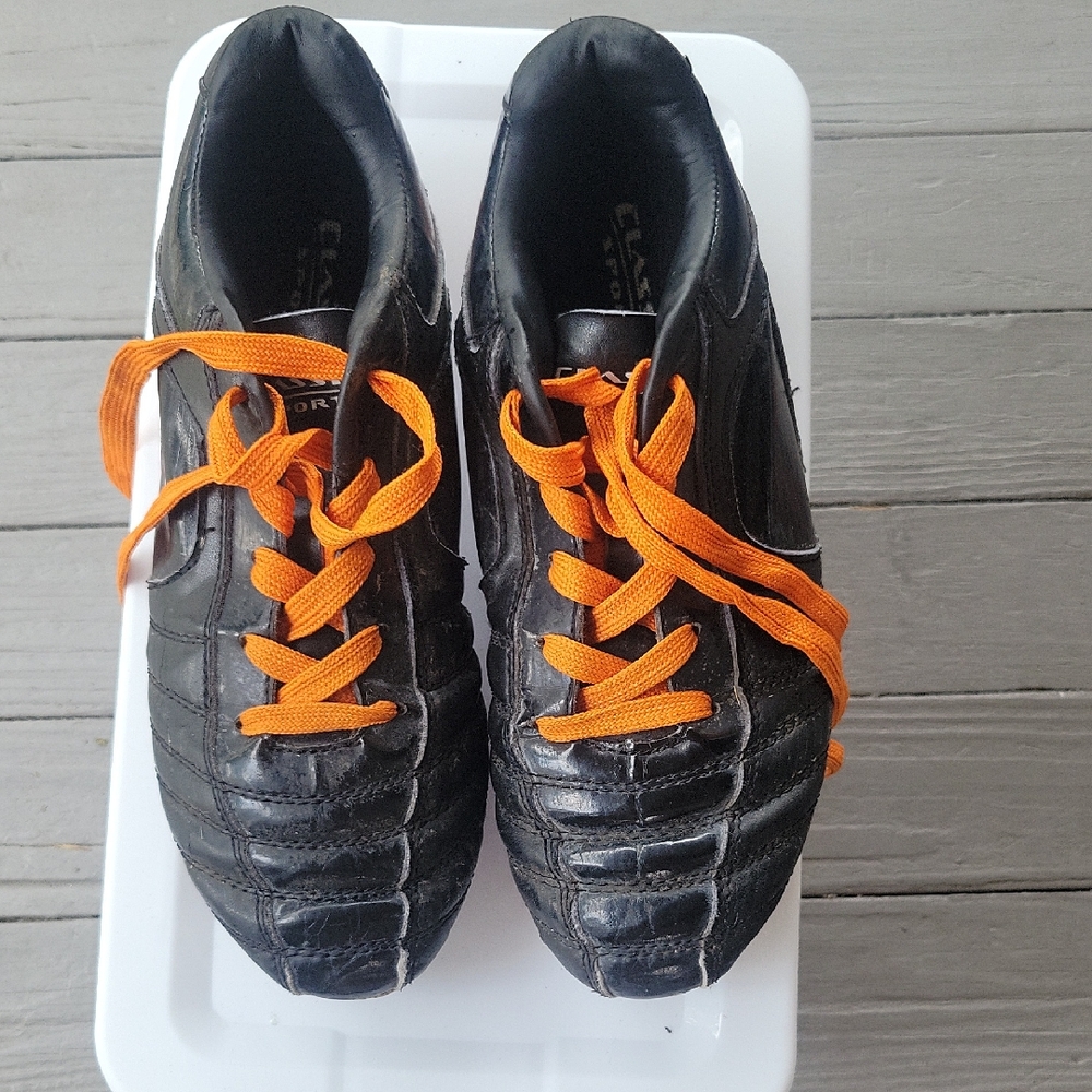 Youth Black Soccer Cleats with Orange Laces
